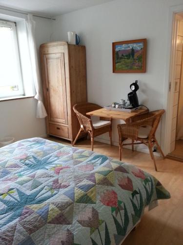a bedroom with a bed and a table and chairs at Thorup Guesthouse in Knebel