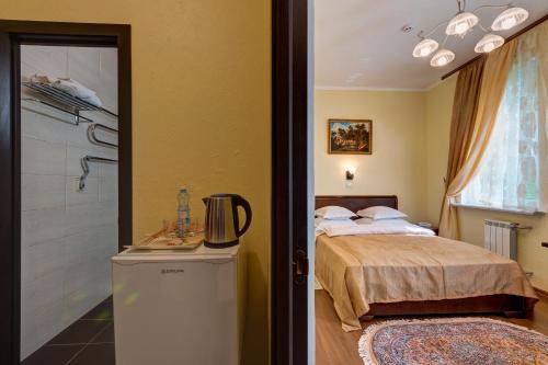Cama o camas de una habitación en Aleksandria Hotel