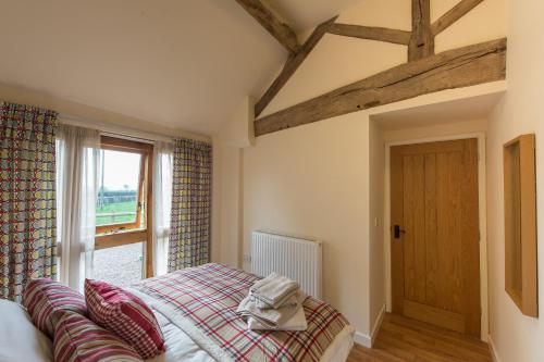 a bedroom with a bed and a window at Paddock Cottage in Newport