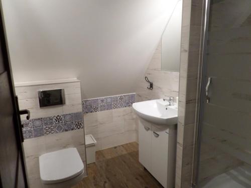 a bathroom with a toilet and a sink at Apartament Lawenda in Łeba