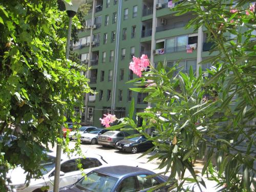 a parking lot with cars parked in front of a building at Apartment Marija Bar in Bar