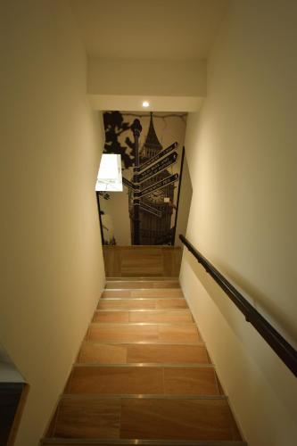 a stairway with a painting on the wall at Chambres d'Hotes Lorengrain in Bruyères-et-Montbérault