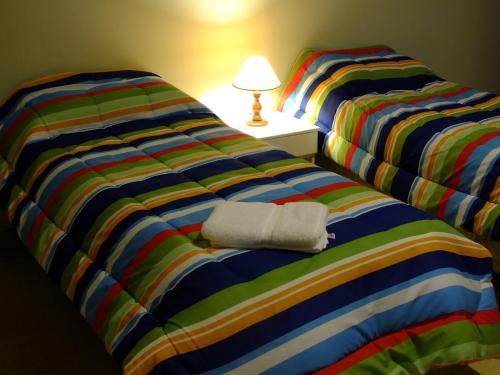 Ένα ή περισσότερα κρεβάτια σε δωμάτιο στο Hostal Amalaya
