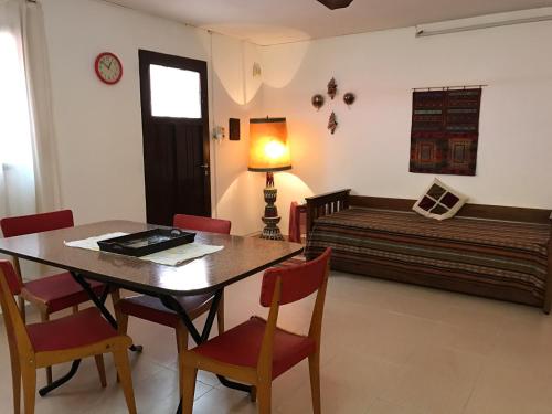 una sala da pranzo con tavolo, sedie e un letto di LF Departamentos a Córdoba