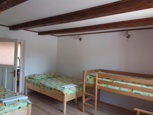 a bedroom with two bunk beds in a room at Maksai Vendégház in Ocna de Sus