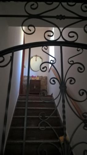 a view of a stairway with a wrought iron railing at La Dea Bendata in Piazza Armerina