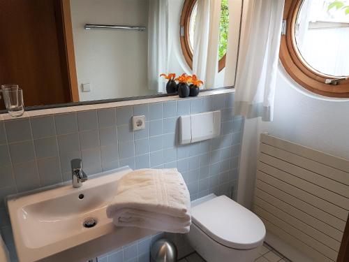a bathroom with a sink and a toilet and a mirror at Apartment St. Leonhard in Überlingen