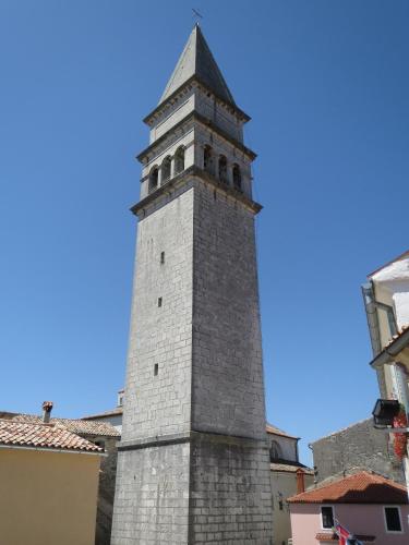 a tall tower with a clock on top of a building at Salvia in Pićan
