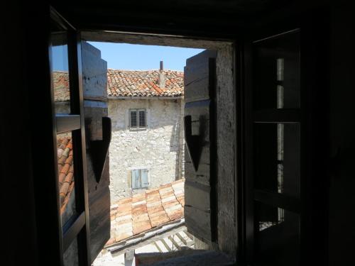 an open window with a view of a building at Salvia in Pićan