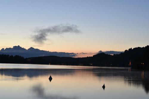 a large body of water with a sunset in the background at Gästehaus Alte Bergmühle in Fischbachau
