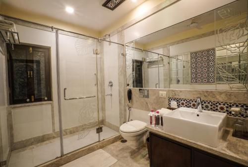 a bathroom with a toilet and a sink and a shower at Shahpura House in Jaipur