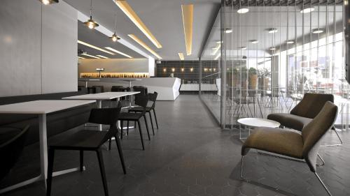 a restaurant with tables and chairs and windows at InterContinental Malta by IHG in St Julian's
