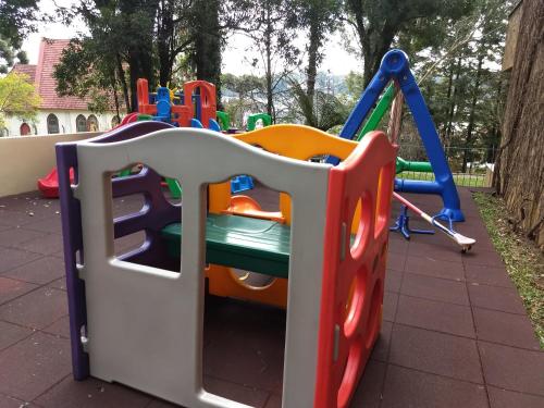 a playground with a slide and a swing at Flat no Hotel Wish Serrano Resort in Gramado