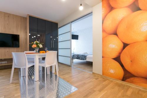 a dining room with a large wall of oranges at VIP Apartamenty Stara Polana 2 in Zakopane