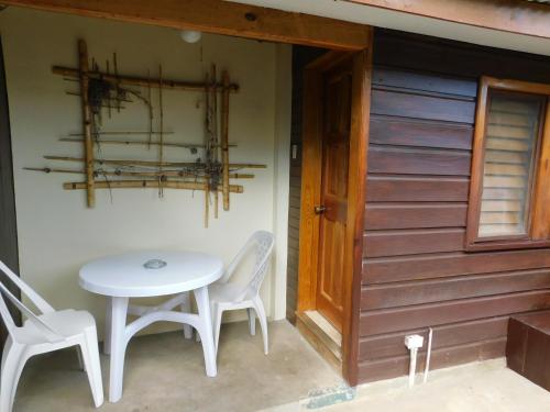 a table and chairs sitting next to a door at Catcha Falling Star in Negril