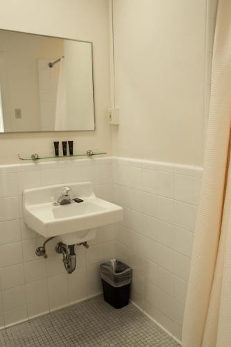 a white bathroom with a sink and a mirror at Missouri Athletic Club in Saint Louis