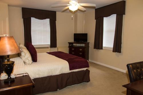 a bedroom with a bed and a ceiling fan at Missouri Athletic Club in Saint Louis