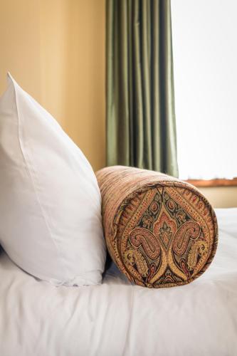 a pillow sitting on top of a bed with pillows at Missouri Athletic Club in Saint Louis