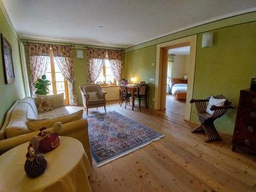 a living room with a couch and a table at Agritur Maso San Bartolomeo in Romeno