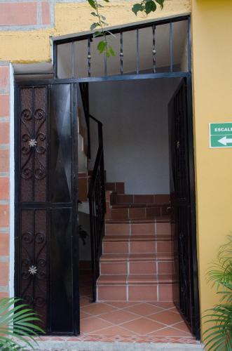an open door of a house with stairs at Hospedaje la Glorieta in Santa Fe de Antioquia