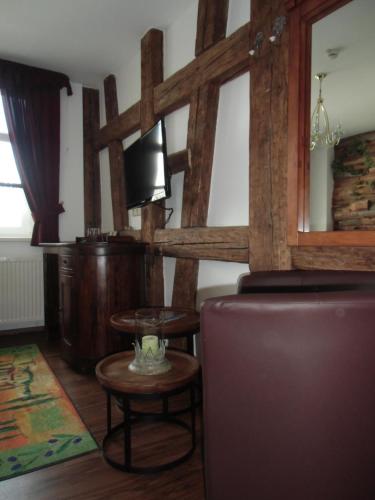 a living room with a table and a chair at Hotel Trendtino in Eisenberg
