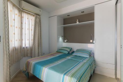 a bedroom with a bed with two pillows at TRG Studio in Arona