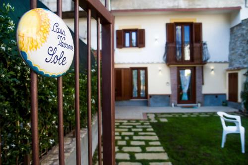 a house with a sign in front of a yard at casa vacanza sole in Tramonti