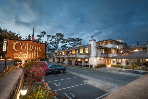 a hotel with a car parked in a parking lot at Colton Inn in Monterey