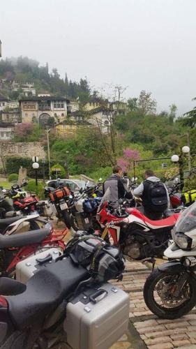 a group of motorcycles parked in a parking lot at Hotel Gjirokastra in Gjirokastër