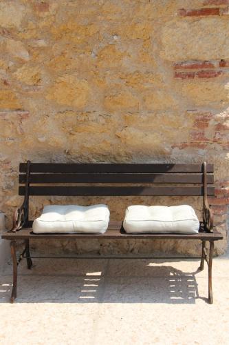 two pillows on a bench in front of a brick wall at Relais Villa Ambrosetti in Verona