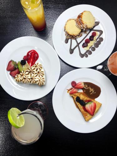 four white plates of food on a table at LaiLa Hotel CDMX Reforma in Mexico City