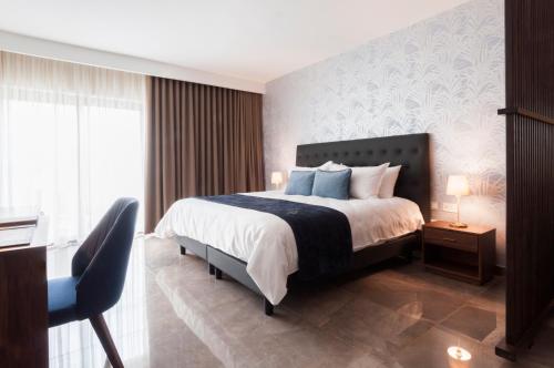 a bedroom with a bed and a table and a chair at The Duke Boutique Hotel in Victoria