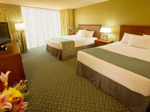 A bed or beds in a room at Aquarius Casino Resort
