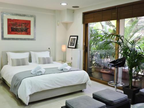 a bedroom with a large bed with towels on it at Luxurious Loft with Garden in Athens