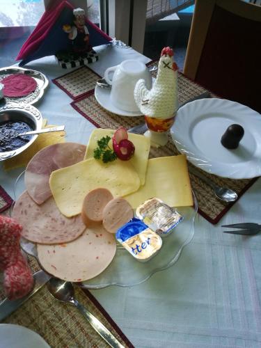 a table with cheese and meats on a plate at Gästehaus Spies in Bullay