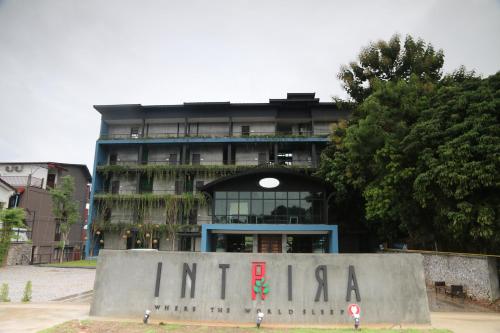 a building with a sign in front of it at Inthira Vangvieng in Vang Vieng