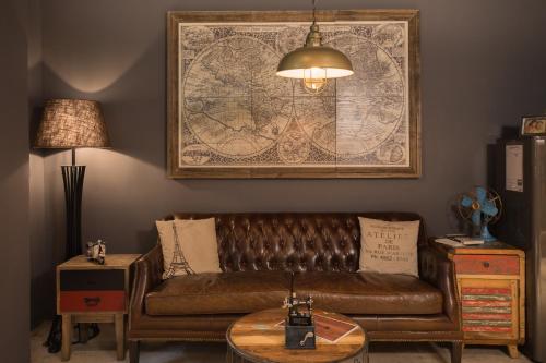 a living room with a couch and a map on the wall at Royal Rose Hotel Shuangcheng Hall in Taipei