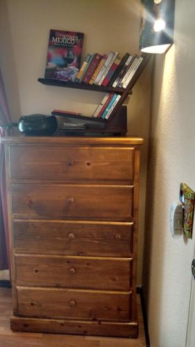 a wooden dresser with books on top of it at Vinofilia Wine Country Inn in Valle de Guadalupe