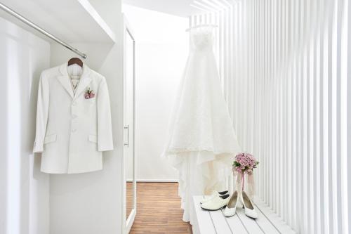 a white wedding dress and shoes on a rack at The Sintesa Residence Jimbaran in Jimbaran