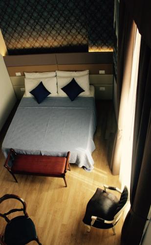 a small bedroom with a bed and a bag at Navona Residenza de Charme in Rome