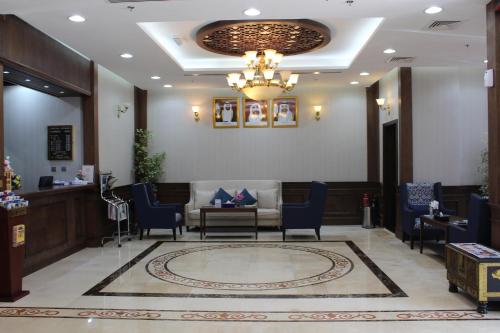 a lobby with a waiting room with a chandelier at Al Diar Mina Hotel in Abu Dhabi