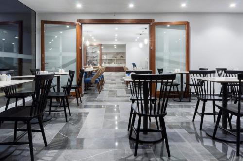 a restaurant with tables and chairs in a room at The Duke Boutique Hotel in Victoria