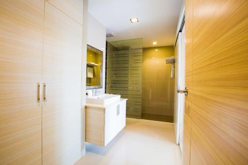 a bathroom with a white sink and a mirror at Romantic Khon Kaen Hotel in Khon Kaen