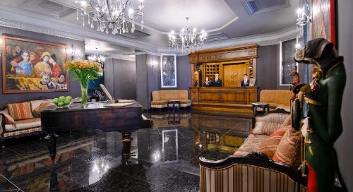 a living room with a grand piano in a room at ALFAVITO Kyiv Hotel in Kyiv