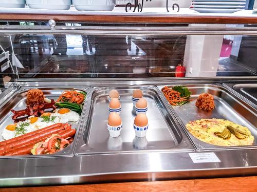 a buffet with eggs and food in a display case at B&B Villa Angy in Korenica