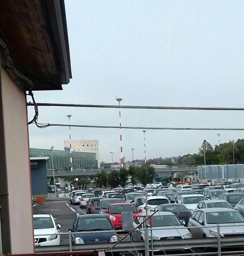 a parking lot filled with lots of parked cars at Fontanarossa Airport Apartment in Catania