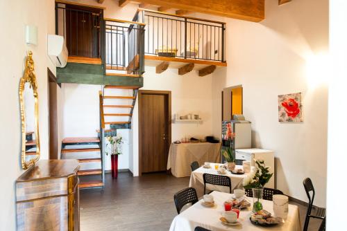 sala de estar con 2 mesas y escalera en Agriturismo Chesini, en Castelnuovo del Garda