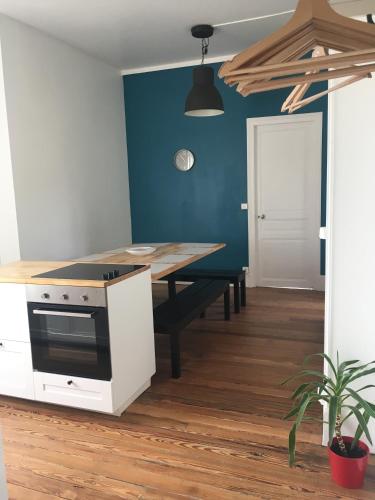 a kitchen with a table and a stove top oven at Le Recommandé in Avize