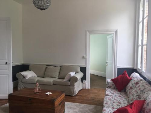 a living room with a couch and a table at Le Recommandé in Avize