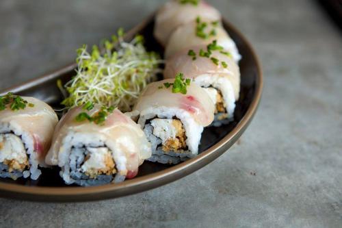 a plate of sushi with a group at Uma Sapna Seminyak in Seminyak